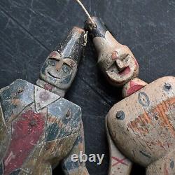 A pair of early 20th Century hand carved Jumping Jack toy figures